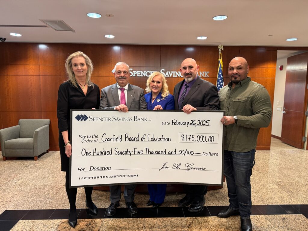 a group of people holding a large check